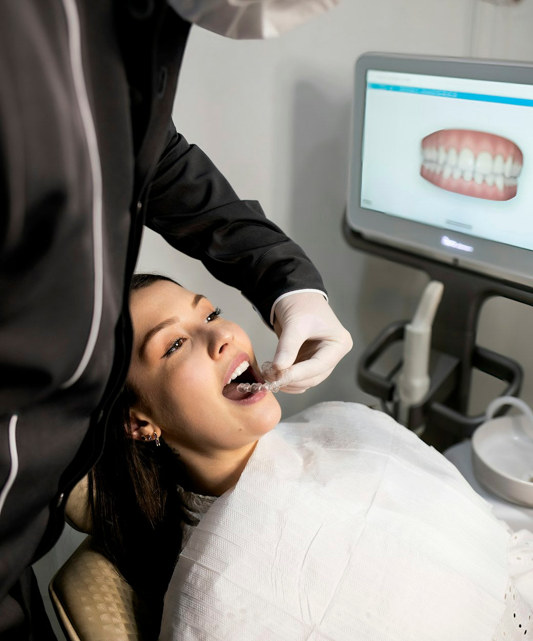 A patient holding a clear aligner
